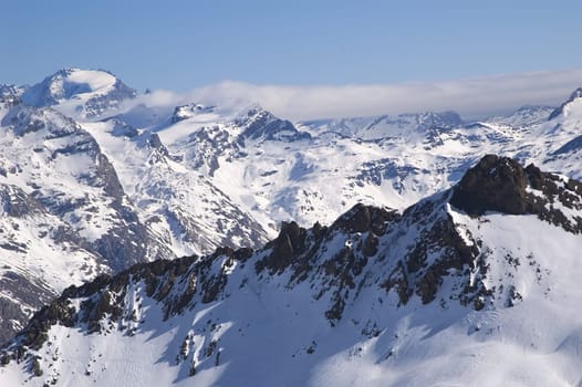 snowed mountainrange with visible rocks  and cloud