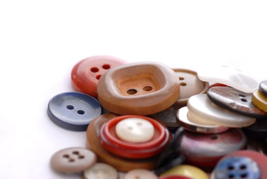 colored sewing buttons on a white background