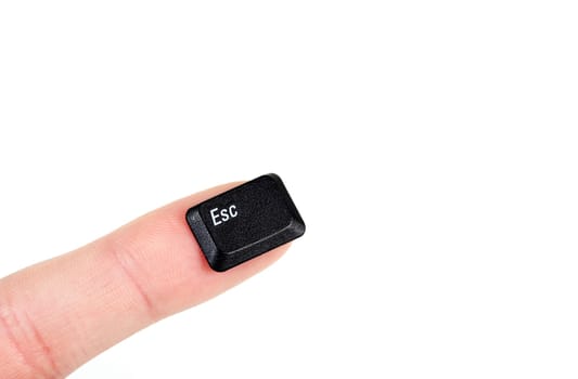 Finger holding the escape key, on white background