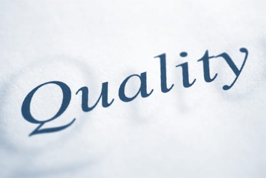quality word written on a white paper