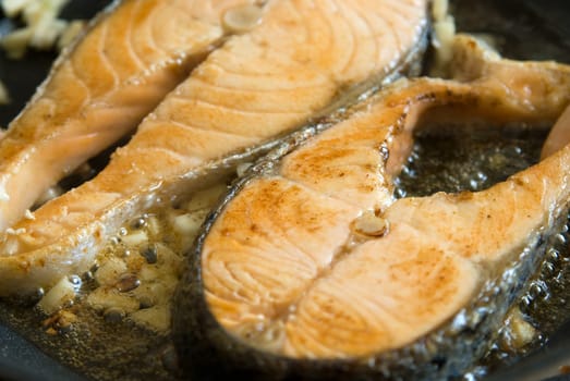 Fillet salmon frying in a pan