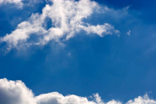 The blue sky and beautiful white clouds.