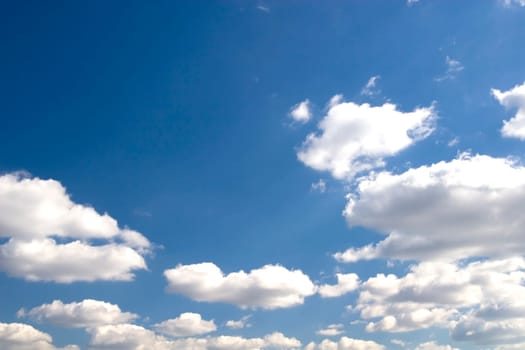 The blue sky and beautiful white clouds.