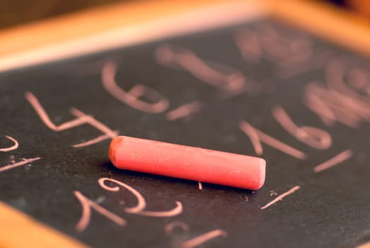 Education blackboard on a brown blurred background