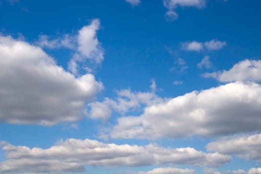 The blue sky and beautiful white clouds.