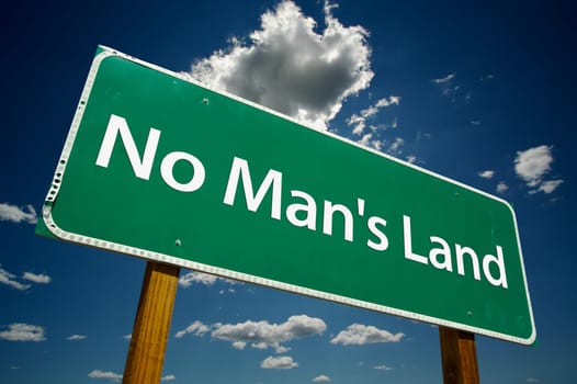 No Man's Land Road Sign with dramatic blue sky and clouds.