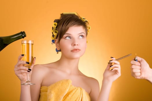 girl with hair-rollers holding a cigarette and a glass of wine