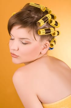 girl with hair-rollers rolled in the towel