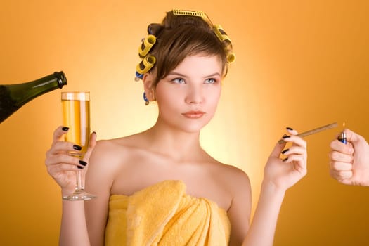 girl with hair-rollers holding a cigarette and a glass of wine