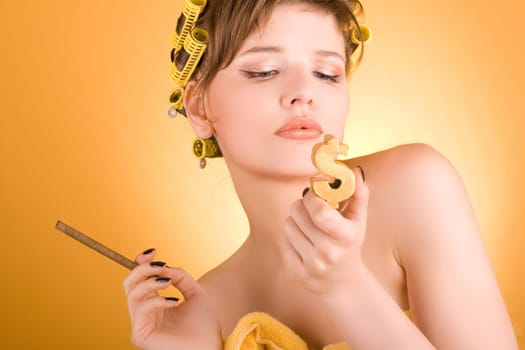 girl with hair-rollers holding a cigarette and a golden dollar