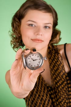 a glamorous girl in the evening dress holding the watch