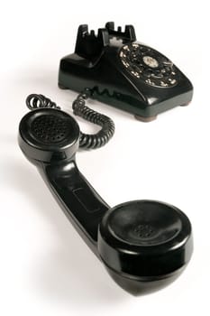 Image of an old beatup rotary telephone. Focus is on the mouthpiece.