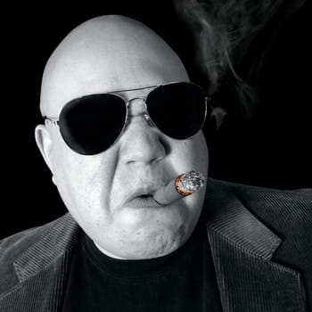 The Loan Shark, Boss, Head Honcho, Top Dog...  An image of the Man in charge, smoking a cigar.
