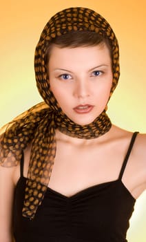 a glamorous girl in the evening dress wearing a scarf