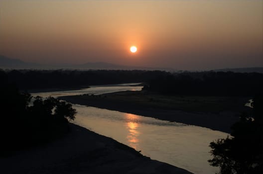 A majestic view of sunrise across the river at Bhalukpong