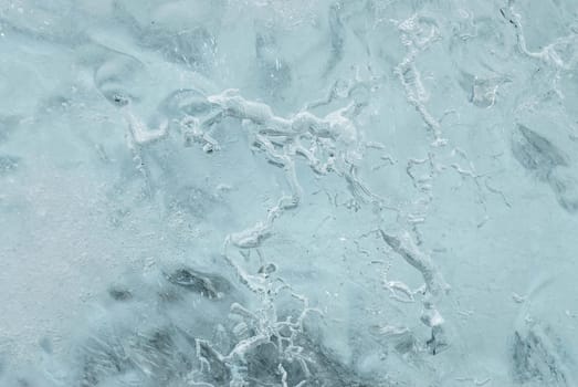 Patterns in a chunk of ice on a beach in Iceland. These chunks of ice fall from the glacier in the lake of Jokulsarlon and are flushed to sea. Most of them are thrown back on the beach before they become water again.