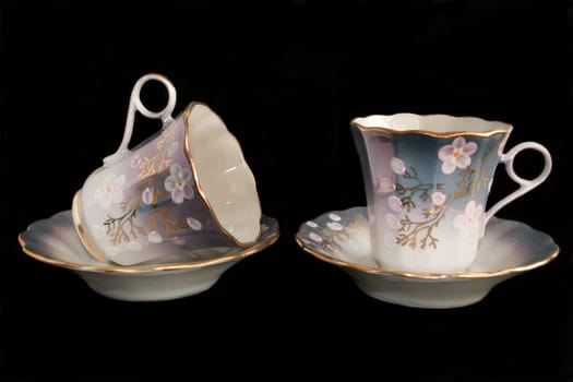 porcelain cup and saucer on a black background