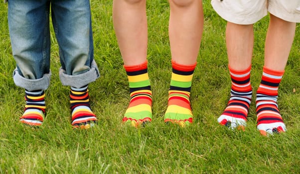 Three kids Wearing Multi colored Toe Socks