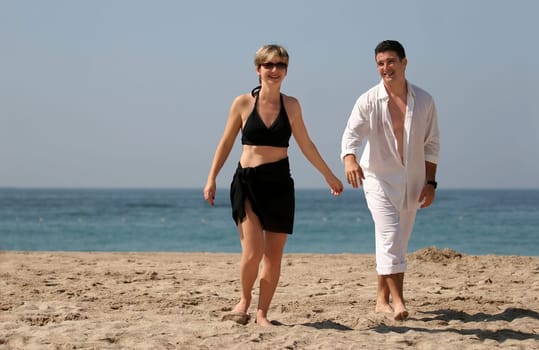 Young couple walking on the beach