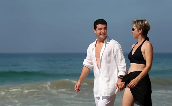 Young couple walking on the beach