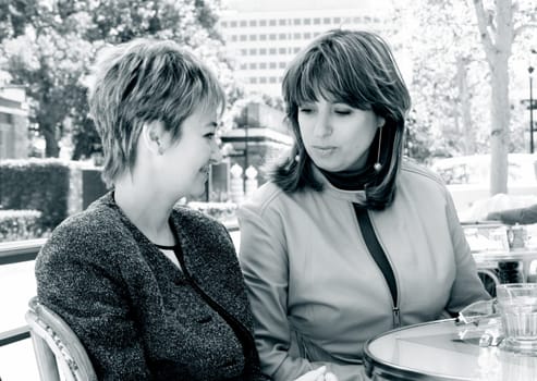 Girlfriends having lunch in a street cafe