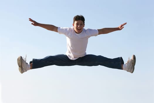 Boy making a split high in the air