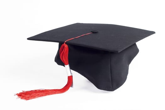 graduation cap with a red tassel isolated on white