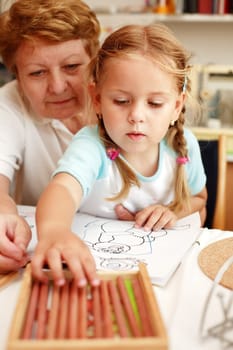 Grandma and grand-daughter painting