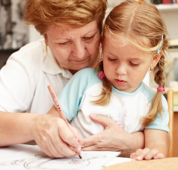 Grandma and grand-daughter painting