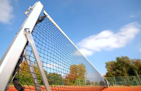 tennis court under blue sky, with focus on the net (wide angle)angel
