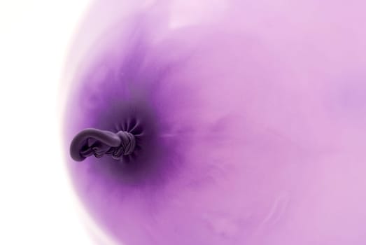 close up of the knot of a purple baloon for festive background