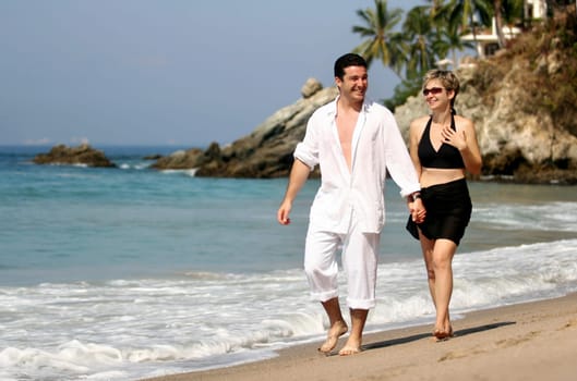 Young couple walking on the beach
