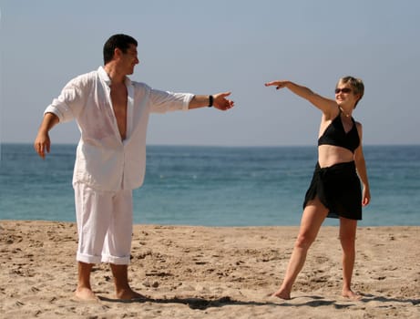 Young couple dancing on the beach