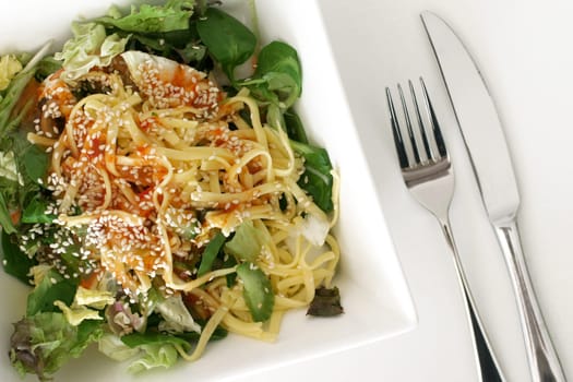 a healthy green salad with shrimps and noodles