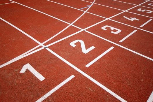 numbers of a racetrack, on red tarmac, for runners
