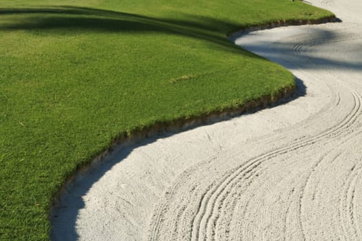 Abstract of bunker and lush Green Grass on a Golf Course.