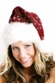 winter portrait of a beautiful young smiling woman with a christmas cap