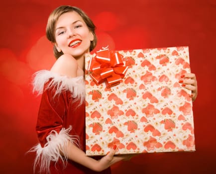 a christmas girl holding a gift box