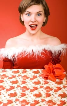 a christmas girl holding a gift box