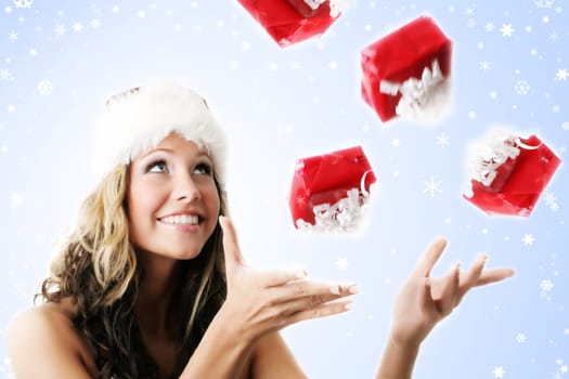 winter portrait of a smiling woman with a gift in her hands and snowflakes