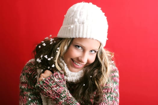 winter portrait of a beautiful young smiling woman with a christmas cap