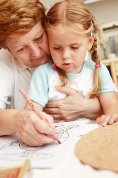 Grandma and grand-daughter painting