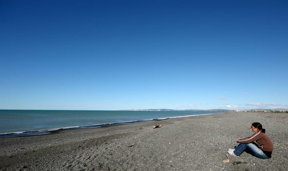 Woman staring out to sea