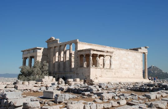 The Erecthion sits on the most sacred site of the Acropolis where Poseidon and Athena had their contest over who would be the Patron of the city. Poseidon thrust his trident into the rock and a spring burst forth, while Athena touched the ground with a sp