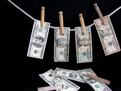 American currency handing on a clothesline.