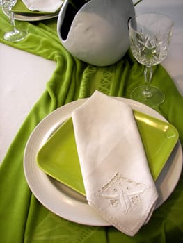 Contemporary dinner setting in green and white.