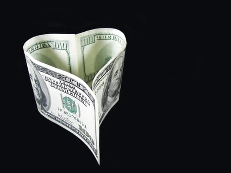 American money formed in shape of a heart.