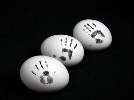 Hand prints on egg shells.