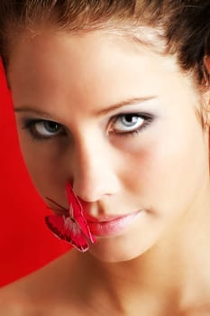 beauty portrait of a beautiful young woman with a butterfly on her lips