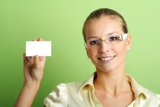 business portrait of a young and successful woman with a businesscard in her hand
